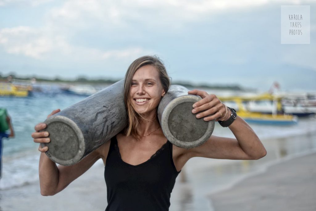 Divemaster Nicole with tanks looking strong